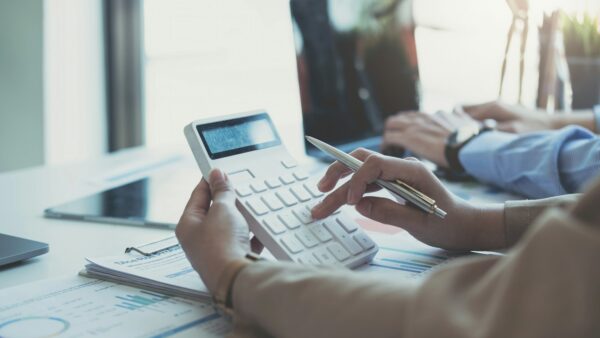 Businesswoman holding calculator for calculate financial data at meeting room, Business Financing